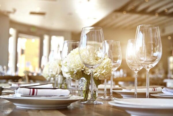 Special Event Insurance - Close-up of a Tasteful Table Set Display of Wine Glasses and Flowers for an Large Event or Celebration